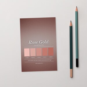 May include: A rose gold colour palette card featuring the text "Rose Gold" and a series of rose gold colour swatches. Two pencils, one teal and one dark green, are positioned to the right of the card. The card also includes the text "COLOR PALETTE" and "JUST ENTER THE HEX CODES ON SHADESURFER".