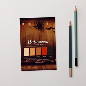 May include: A Halloween color palette card with a wooden background, spider, and bats. The card displays a color palette with hex codes and the text "Halloween COLOR PALETTE". Two pencils are on the right.