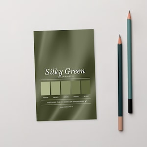 May include: A colour palette card labelled "Silky Green" with five shades of green, and two pencils. The card includes the text "COLOR PALETTE" and "JUST ENTER THE HEX CODES ON SHADESURFER". The pencils are dark green and teal.