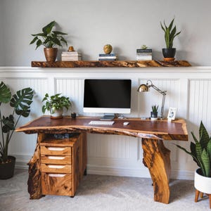 May include: A set of three ceramic mugs with a speckled, cream-colored glaze. Each mug features a different hand-painted design: a blue and green leaf, a yellow flower, and a red berry. The mugs have a simple, modern design.