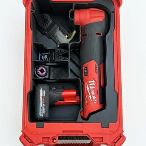 May include: A red and black Milwaukee multi-tool kit. The kit includes a red case with a clear lid, a multi-tool, a battery, and various blades. The multi-tool is black and red, with the Milwaukee logo.