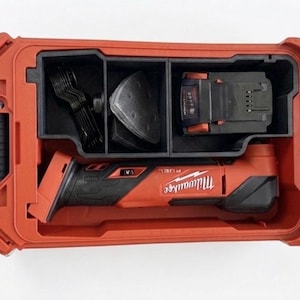 May include: Red and black Milwaukee FUEL oscillating multi-tool kit. The kit includes the tool, battery, charger, and various accessories, all stored in a durable red case. The case is open, revealing the organized contents.