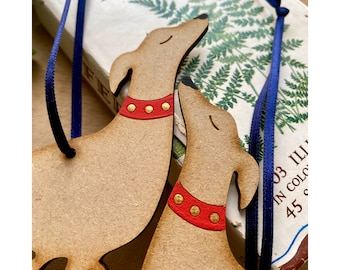 A Pair of Wooden Hound Decorations