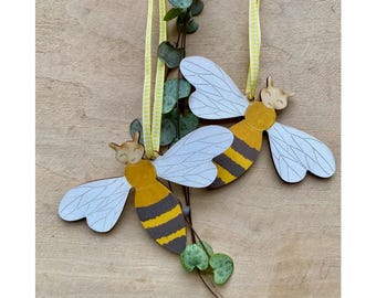 A Pair of Hand Painted Bee Decorations