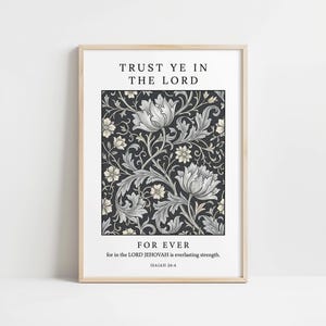 May include: A framed art print featuring the text "TRUST YE IN THE LORD FOR EVER" above a floral pattern. The floral design has large white and gray flowers on a dark background. The bottom of the print includes the text "for in the LORD JEHOVAH is everlasting strength. ISAIAH 26:4."
