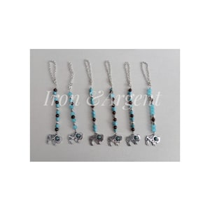 May include: Six silver-toned metal charms featuring a buffalo silhouette pendant with a turquoise inlay. Each charm hangs from a silver chain accented with alternating light blue and dark brown beads, with the text Iron & Argent overlaid.