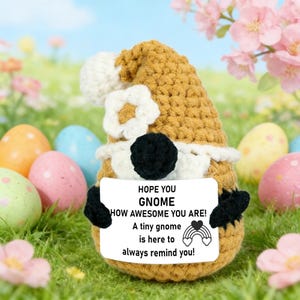 May include: A white ceramic mug with a black handle and the text "But First, Coffee" in a black, handwritten-style font. The mug is on a white surface.