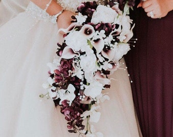 Cascading plum bridal bouquet with picasso calla lilies, peonies, orchids, plum and white bouquet