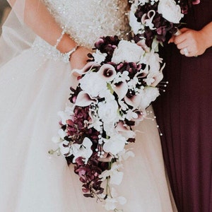 Cascading plum bridal bouquet with picasso calla lilies, peonies, orchids, plum and white bouquet