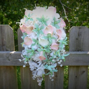 Cascading mint, light pink, white hydrangea, real touch calla, orchid bouquet pearl accent