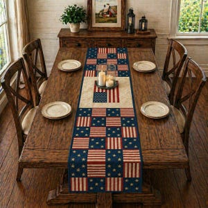 May include: A wooden dining table set with four chairs, four plates, and a patriotic table runner. The runner features a patchwork design with red and white stripes, blue fields with white stars, and a central American flag.