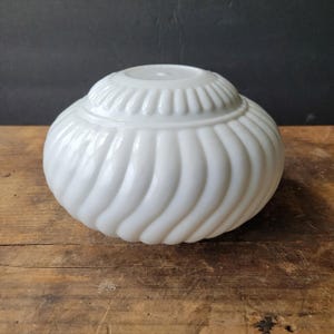 May include: A set of three ceramic mugs with a speckled, matte finish. The mugs are in shades of cream, light gray, and dark gray. Each mug has a simple, minimalist design, perfect for coffee or tea.