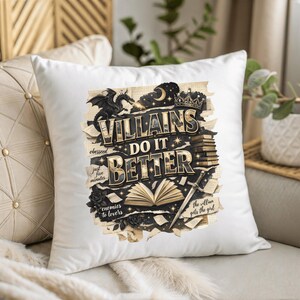 May include: White square pillow with the text "VILLAINS DO IT BETTER" in gold and black. The design includes a dragon, crown, sword, and open book illustrations. Additional text includes "obesseed", "just five minutes", "enemies to lovers", and "the villian gets the girl".