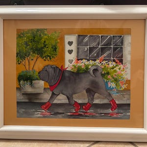 May include: Watercolor painting of a Shar Pei dog wearing a red bandana and red boots, walking on a wet street. The background features a building with a window, flowers, and a tree, all within a white framed artwork.