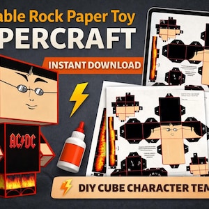 以下が含まれることがあります： メガネとAC/DCのシャツを着た立方体キャラクターが特徴の、印刷可能なペーパークラフトのおもちゃ。画像には、DIYキューブキャラクターテンプレート、ハサミ、接着剤、ペーパークラフトのデザインを表示するタブレットが含まれています。「Printable Rock Paper Toy PAPER CRAFT」と「Instant Download」と書かれています。