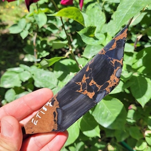 May include: A flat, elongated piece of black and brown matrix stone with a polished surface. The stone features a distinct web-like pattern of dark brown veins running through the black base. The text ET187 is written in white on the lower left.