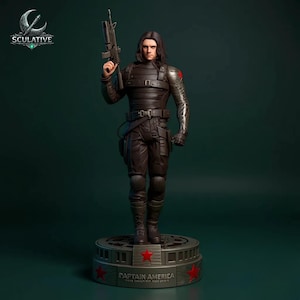 May include: A detailed figurine of a character from Captain America, holding a rifle. The figure is dressed in a dark outfit with a metallic arm and a red star emblem. The base reads "Captain America" with red star accents.