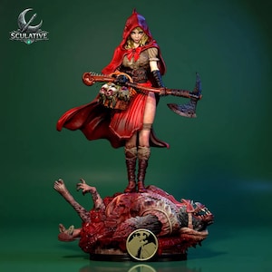 May include: A detailed figurine of a woman in a red hooded cloak, holding an axe and a basket with skulls. She stands atop a defeated wolf-like creature. The figurine has a dark green background and the word "SCULATIVE" is visible.