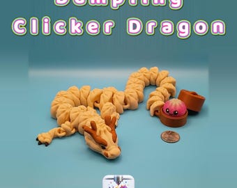 May include: A beige articulated dragon figure with brown accents, shaped like a series of dumplings. It holds a small brown container with a pink dumpling inside. The text Dumpling Clicker Dragon is displayed above, and a small logo for Creatively Cubic is below.