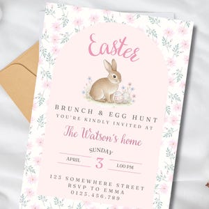 May include: An Easter invitation with a light pink background and floral border. The invitation features a bunny illustration, the word "Easter", and details for a brunch and egg hunt, including the date, time, and location.