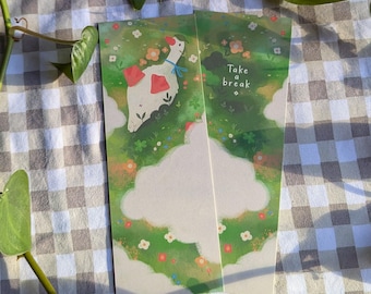 Puede incluir: Dos marcapáginas ilustrados con un diseño caprichoso. Un marcapáginas presenta un ganso blanco con detalles rojos y un lazo azul, sobre un prado verde con flores. El otro marcapáginas tiene el texto "Take a break".