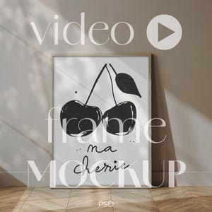 May include: A framed art print featuring a black and white illustration of two cherries with a leaf. The words "ma cherie" are written below the cherries. The word "video" is at the top, and "frame mockup" is written on the frame.