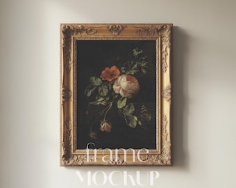 May include: A rectangular ornate gold-colored frame containing a dark painting of a floral arrangement with white and orange roses and green leaves. The text "frame MOCKUP" is overlaid in white in the center of the image, with "PSD - JPG" below.