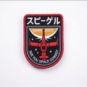 May include: Embroidered patch with a red border and a black background. The patch features a red spaceship design, Japanese text, and the phrase "SEE YOU SPACE COWBOY." The patch also includes the numbers 2044 and 2071.