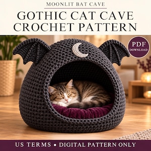 May include: A dark gray crochet cat cave featuring bat wings on the sides and a crescent moon applique on the top. A brown tabby cat sleeps inside on a deep purple cushion. Text reads: MOONLIT BAT CAVE GOTHIC CAT CAVE CROCHET PATTERN PDF DOWNLOAD US TERMS DIGITAL PATTERN ONLY.