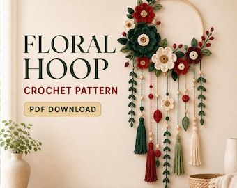 May include: A wall hanging featuring a wooden hoop decorated with crocheted red, dark green, and cream flowers, leaves, and berries, with hanging strands of beads, leaves, and tassels. Text reads: FLORAL HOOP CROCHET PATTERN PDF DOWNLOAD.