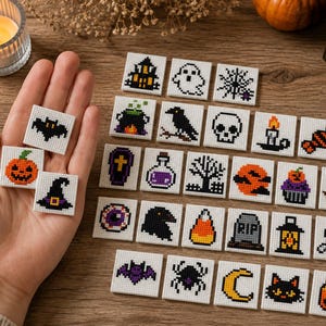 May include: A collection of square tiles featuring various Halloween-themed cross-stitch patterns, including a pumpkin, bat, witch hat, ghost, spider web, skull, raven, coffin, potion bottle, candy corn, tombstone, mummy, and black cat.