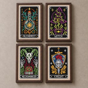 May include: Four framed cross-stitch artworks featuring fantasy character themes. Each rectangular piece displays a black background with colorful pixelated designs labeled Alchemist, Witch, Necromancer, and Knight in dark wooden frames.