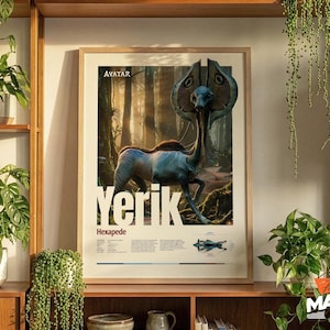 May include: A framed poster featuring a creature from the movie Avatar, with the name "YERIK" in large white letters. The poster has a light wood frame and is displayed on a wooden shelf with plants.