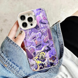 May include: A clear phone case with a vibrant purple anime-style graphic. The design features multiple characters and the text "SO COOL". The case has a white camera module and is held by a person wearing a denim jacket.