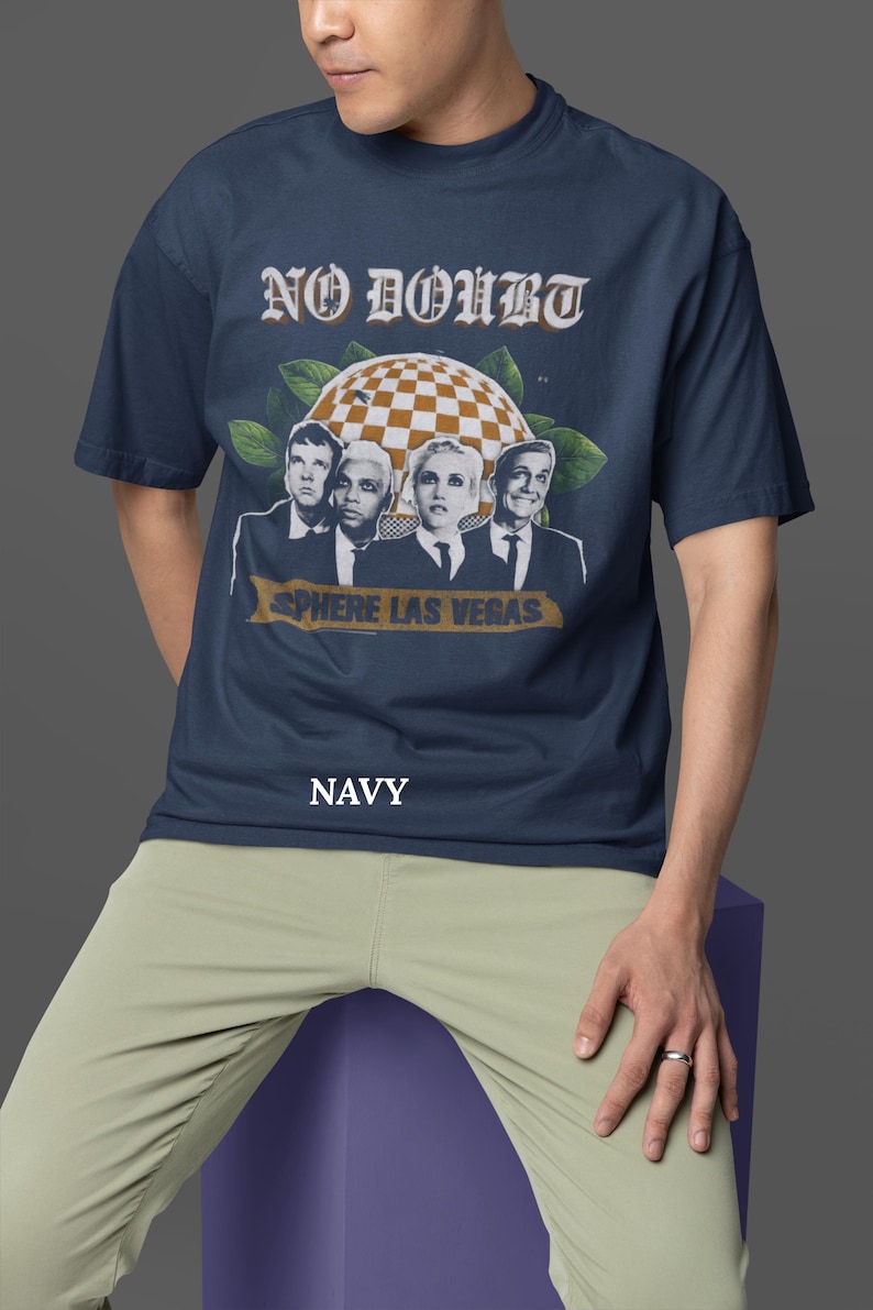 May include: Navy blue t-shirt featuring the band No Doubt with the text "NO DOUBT" in a vintage font. The shirt has a graphic of the band members and the text "SPHERE LAS VEGAS". The word "NAVY" is printed at the bottom.