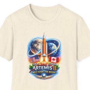 May include: A white ceramic mug with a black handle and the text "But First, Coffee" in a black, handwritten-style font. The mug is on a white surface.