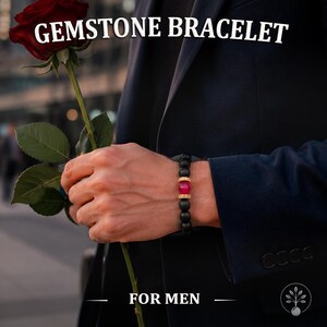 May include: A beaded bracelet featuring matte black spherical beads, a central translucent red bead, and gold-toned metallic spacers with embedded crystals. The text GEMSTONE BRACELET FOR MEN is visible at the top and bottom of the image.