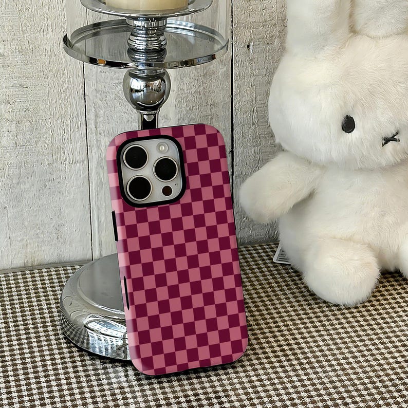 Pink Red Checkers Sweet Phone Case—a "strawberry milk" for girls. Inspired by sweet strawberry desserts, this case cleverly combines soft "Pink" with vibrant "Red" checkers, instantly filling the atmosphere with sweet "Girly" vibes. This design with a built-in soft light filter offers both retro playfulness and an energetic vibe that lifts your mood. It fits iPhone and Samsung series perfectly, making it an excellent accessory for creating date sweet-style or Japanese girl outfits.