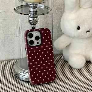 This Vintage Coquette Burgundy & Pink Heart phone case combines sweet heart motifs with a simple, cute design, creating a playful and girly look. The rich burgundy and soft pink tones blend elegantly for a charming, vintage-inspired aesthetic. High-quality printing captures every detail, while a durable protective structure guards against scratches, drops, and daily wear. Slim, lightweight, and comfortable to hold, it’s perfect for anyone seeking a stylish, retro, and adorable phone cover.