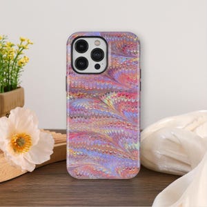 May include: A colorful phone case with a swirling, marbled pattern in shades of pink, purple, and yellow. The case has a glossy finish and a black camera cutout. The case is designed to fit a smartphone.
