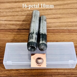 May include: Two metal stamping tools with 16-petal designs, 10mm in size, are displayed next to a stamped copper square. The tools are in a clear plastic case. The text "16-petal 10mm" is above the tools.