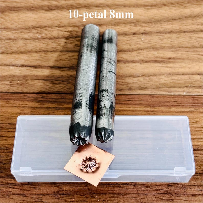 May include: Two metal tools with a 10-petal design, 8mm in size, next to a copper square with an embossed flower. The tools are cylindrical with a textured finish. A clear plastic case is also present. The text "10-petal 8mm" is at the top.