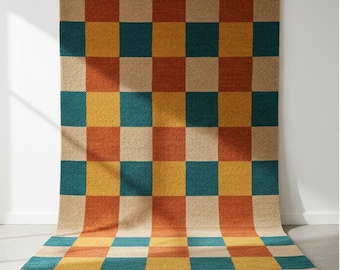 May include: A large, rectangular rug with a checkerboard pattern. The squares alternate between teal, orange, yellow, and beige. The rug is made of a textured material and is displayed against a white wall.