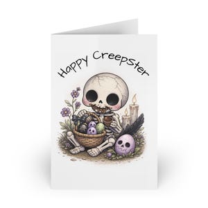 May include: A white greeting card featuring a cartoon skeleton with a basket of decorated eggs. The card reads "Happy Creepster". The skeleton is surrounded by flowers, candles, and a purple skull, creating a spooky Easter theme.