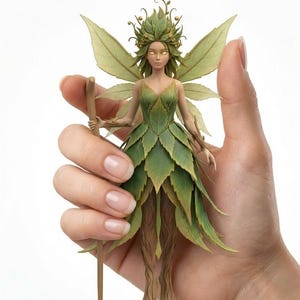 May include: A detailed figurine of a fairy, held in a hand. The fairy is dressed in a green leaf-like gown and has matching wings. Her hair is adorned with leaves and golden berries, and she holds a wooden staff. The fairy's skin is pale, and her eyes glow.