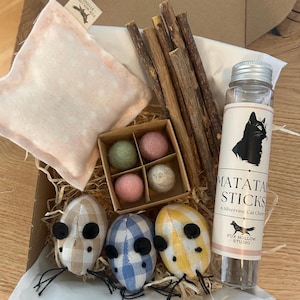 May include: A white ceramic mug with a black handle and the text "But First, Coffee" in a black, bold font. The mug is on a white surface.