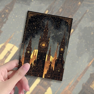 May include: A rectangular art print depicting a detailed illustration of a city skyline at night. The artwork shows tall, ornate buildings with illuminated windows and spires, set against a starry sky and a large, glowing moon. The color palette is mainly dark brown and gold.