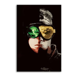 May include: A portrait-style print featuring a person wearing goggles with green and yellow lenses. The person's face is divided, with one side in shadow and the other in light. The background is black, creating a striking contrast.