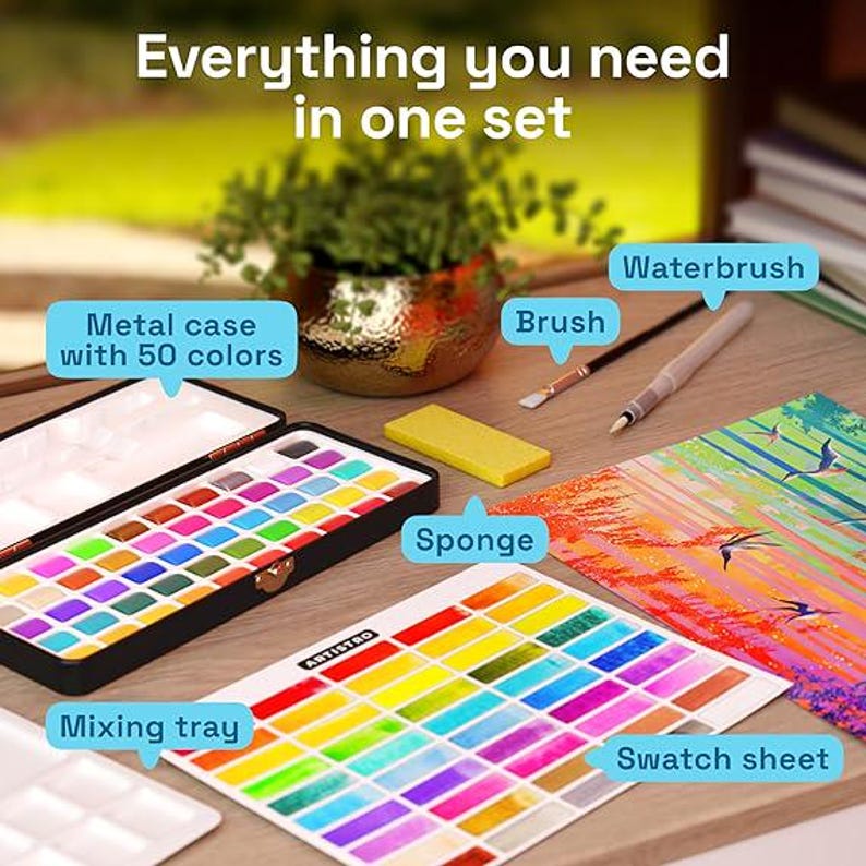 May include: A watercolor painting set featuring a black metal case with 50 paint pans, a white mixing tray, a yellow sponge, a brush, and a waterbrush. A swatch sheet displays the colors, and text reads: Everything you need in one set.