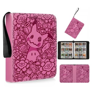 May include: A pink trading card binder featuring a dark pink doodle-style pattern of the character Mimikyu surrounded by various flowers and foliage. The binder includes a black carrying strap, a matching wristlet, and internal card storage pages.